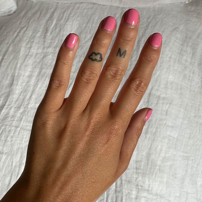 A hand with nails painted pink