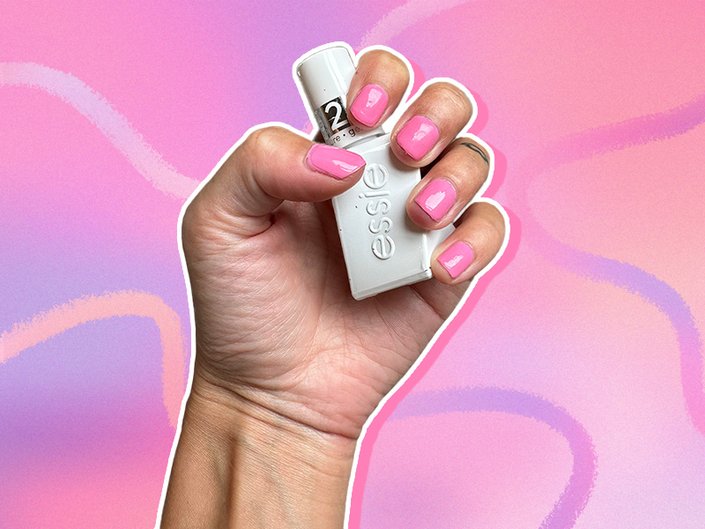 Photo of a hand with nails painted pink holding up the Essie Gel Couture Top Coat, against a pink and purple graphic background