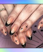 Photo of someone’s nails painted with black and gold French tips and sparkles, collaged on a rainbow tie-dye background