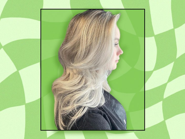 Photo of a person with blonde hair cut in a layered butterfly haircut on a green checkered background