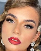 person wearing eyelash extensions and red lipstick
