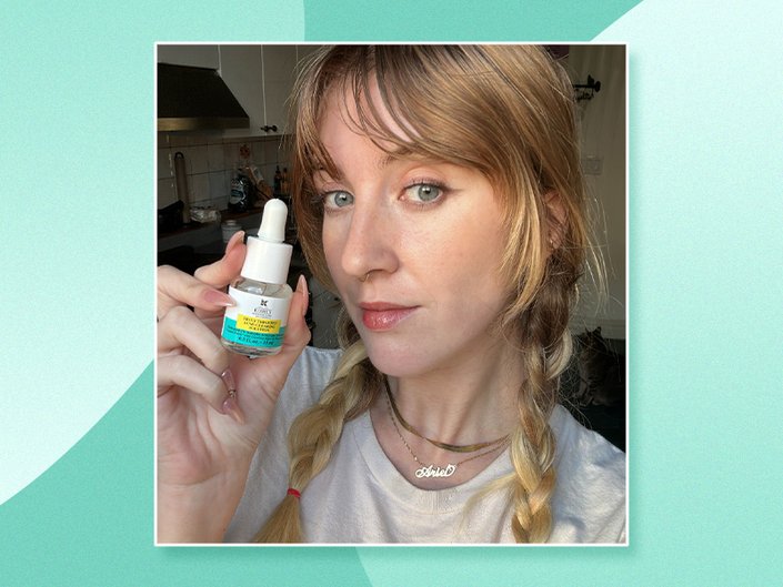 Picture of an editor holding the Kiehl’s Truly Targeted Acne-Clearing Pimple Patch with Salicylic Acid on a turquoise graphic background