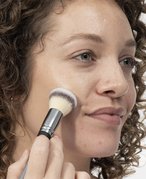 Collage of a woman applying foundation with a brush, a brush, and a pink sponge
