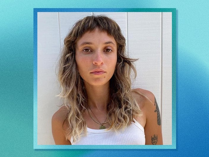 person with micro bangs on blue graphic background