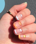 hand with half moon nail art on nails