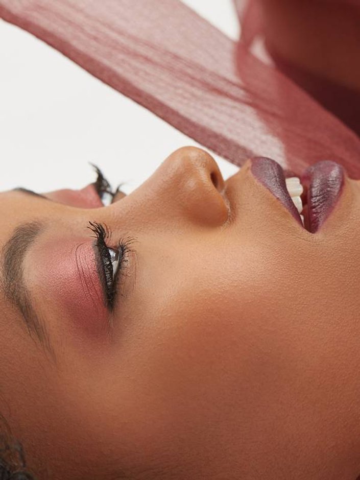 person with dark skin tone wearing dark lipstick