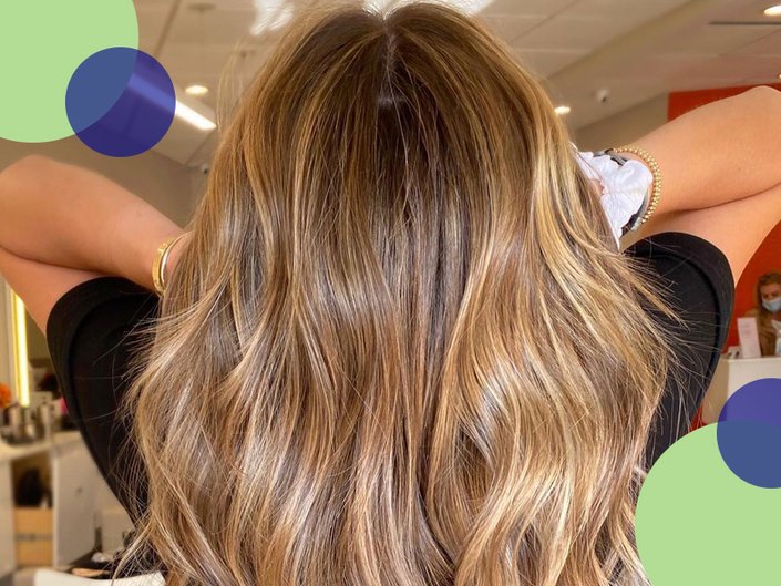 Back of the head of a person with long hair and highlights