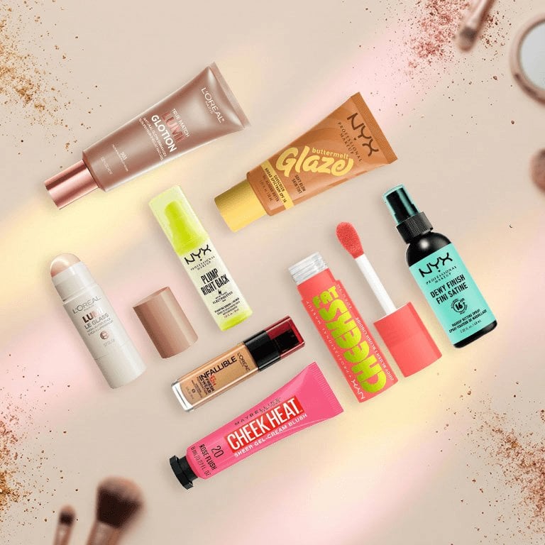 L’Oreal Paris, NYX Professional, and Maybelline New York makeup products on a textured background