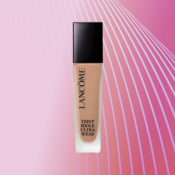 A bottle of Lancome Teint Idole Ultra Wear on a pink background